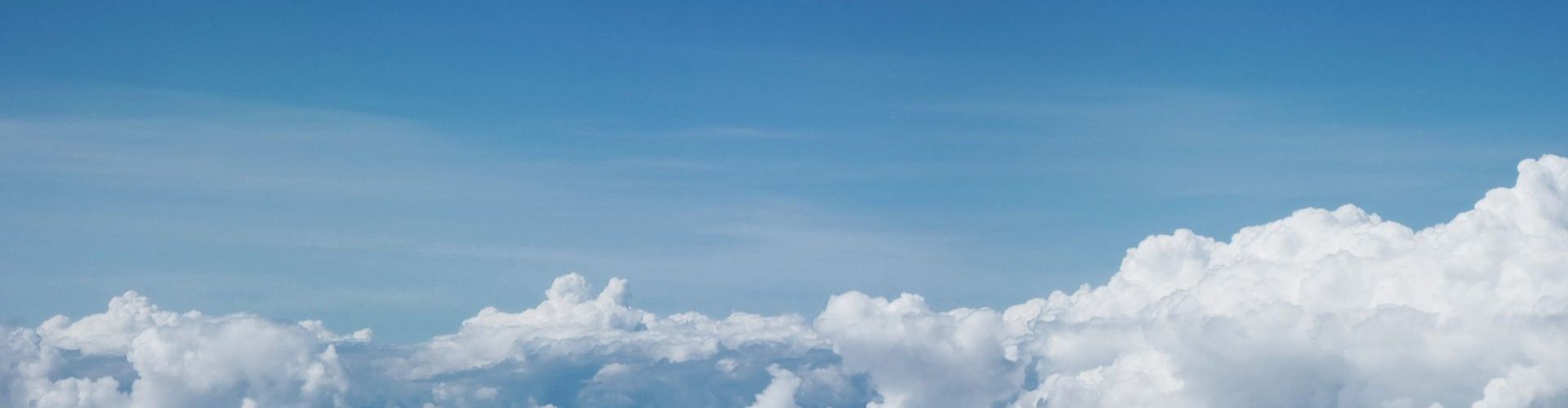 Bright blue sky with fluffy white clouds